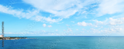 Fototapeta Naklejka Na Ścianę i Meble -  cloudy blue sky leaving for horizon above a blue surface of the sea