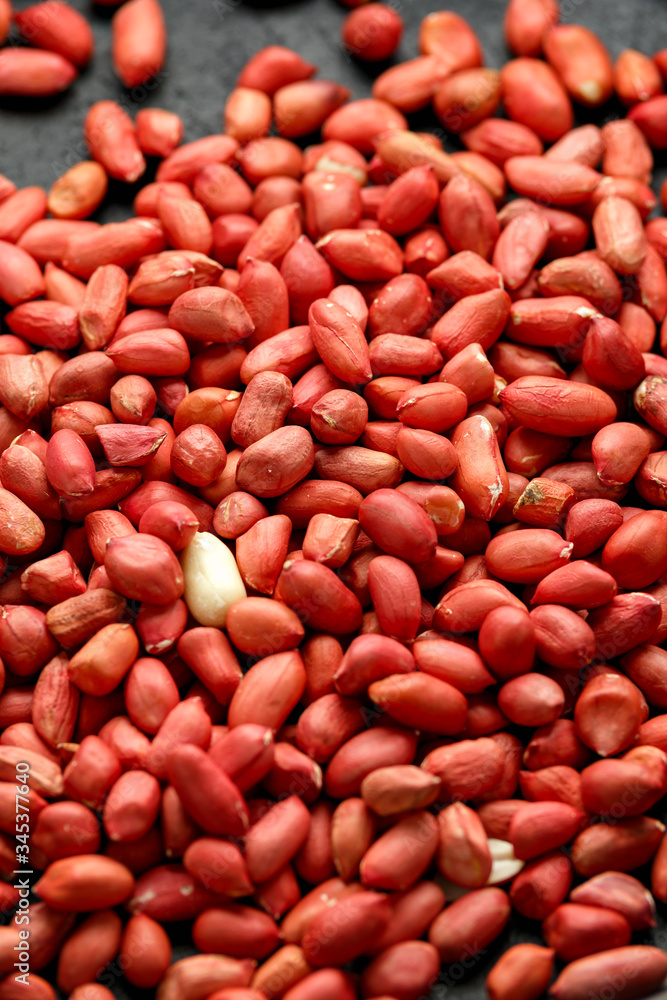 Peanuts in wooden bowl on rustic background Peanuts in wooden bowl on rustic background