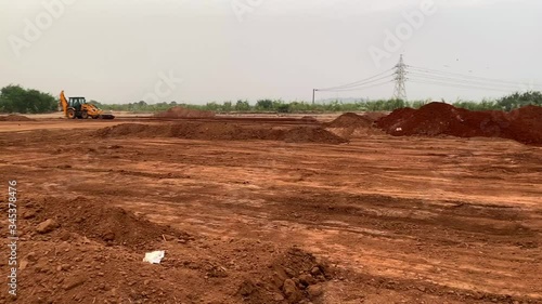 Lots of red clay and a bulldozer at Madh Island Mumbai. photo