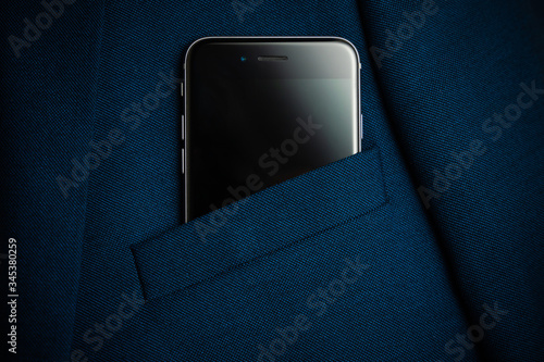 Foto Black smartphone in men suit pocket close up.