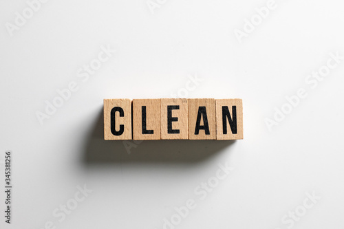 " clean " text made of wooden cube on White background.