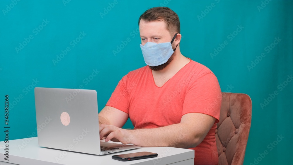 Caucasian adult bearded man works at home. Lifestyle concept photo with copy space. picture with a handsome guy who uses a protective mask. Caucasian adult bearded man works at home. Lifestyle concept photo with copy space. picture with a handsome guy who uses a protective mask.