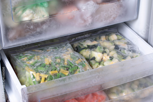 Bags with frozen vegetables in refrigerator. Frozen Asparagus Beans