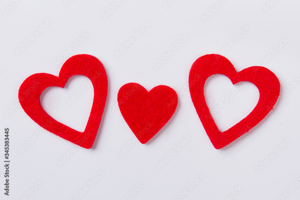 Three flat red hearts with fibre surface. Isolated on white background.