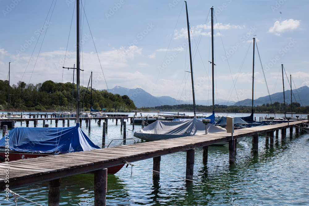 .yachts at the pier of the lake. View of the mountains. Bavaria. Germany.Simssee.Prien.Bayern