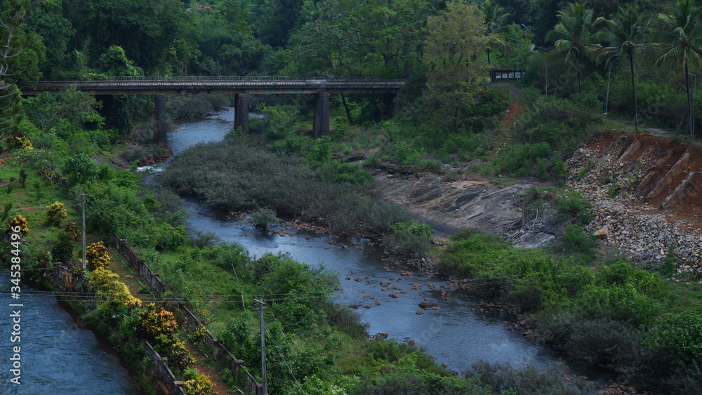 Fototapeta premium LONG RIVER CROSSING BRIDGE IN BEAUTIFUL LANDSCAPE