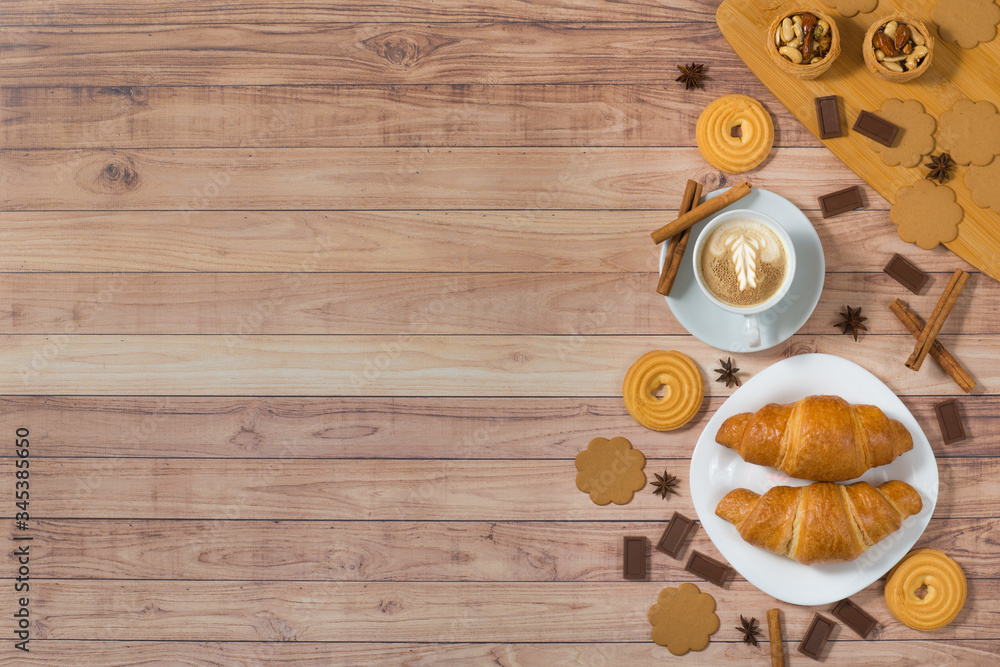 Flat lay cup of coffee, croissants, cookies and chocolate on rustic wooden table. Breakfast at morning. Top view, place for text. Design banner concept Flat lay cup of coffee, croissants, cookies and chocolate on rustic wooden table. Breakfast at morning. Top view, place for text. Design banner concept