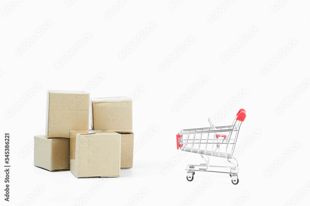 A pile of brown parcel boxes and red shopping carts isolated on white background with copy space