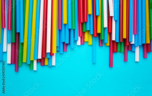 drinking straws for a party on a blue background. template with space for text