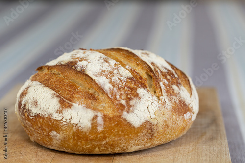 Freshly baked homemade sourdough bread on a wooden board