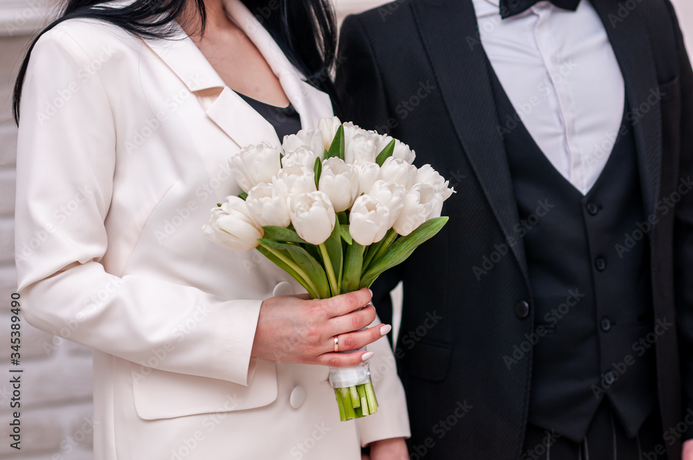 White wedding bouquet in the hands of bride White wedding bouquet in the hands of bride