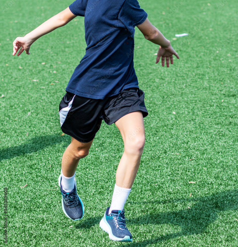 Young athlete warming during practice up on turf field Young athlete warming during practice up on turf field
