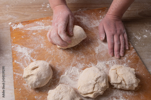 Female hands mixing dough in the home kitchen.