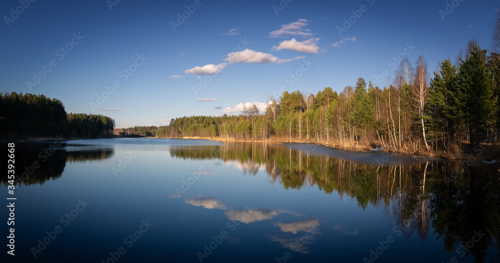 spring landscape of a lake with a forest on the shore, Russia, Ural, may
