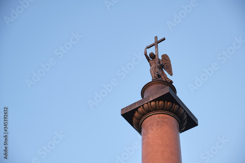 Angel on the Alexandrian pillar in St. Petersburg against the blue sky