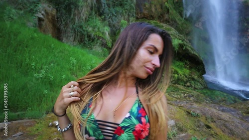 Young sexy model on Navajos waterfall background 