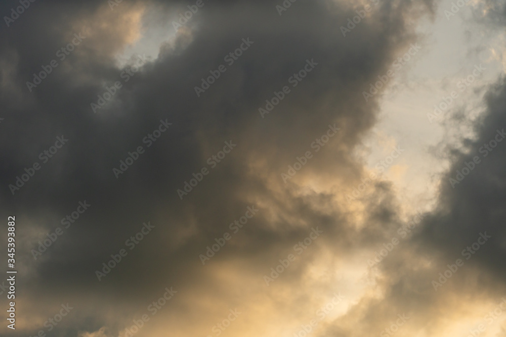 Gray clouds are lit by the setting sun. The sky after the rain. Gray clouds are lit by the setting sun. The sky after the rain.