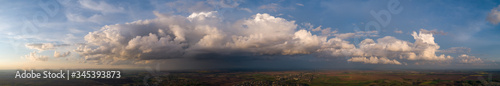 The stormy clouds on sunset panorama photo