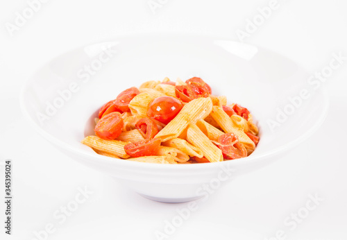 Penne with tomatoes, garlic and mozzarella on a white background