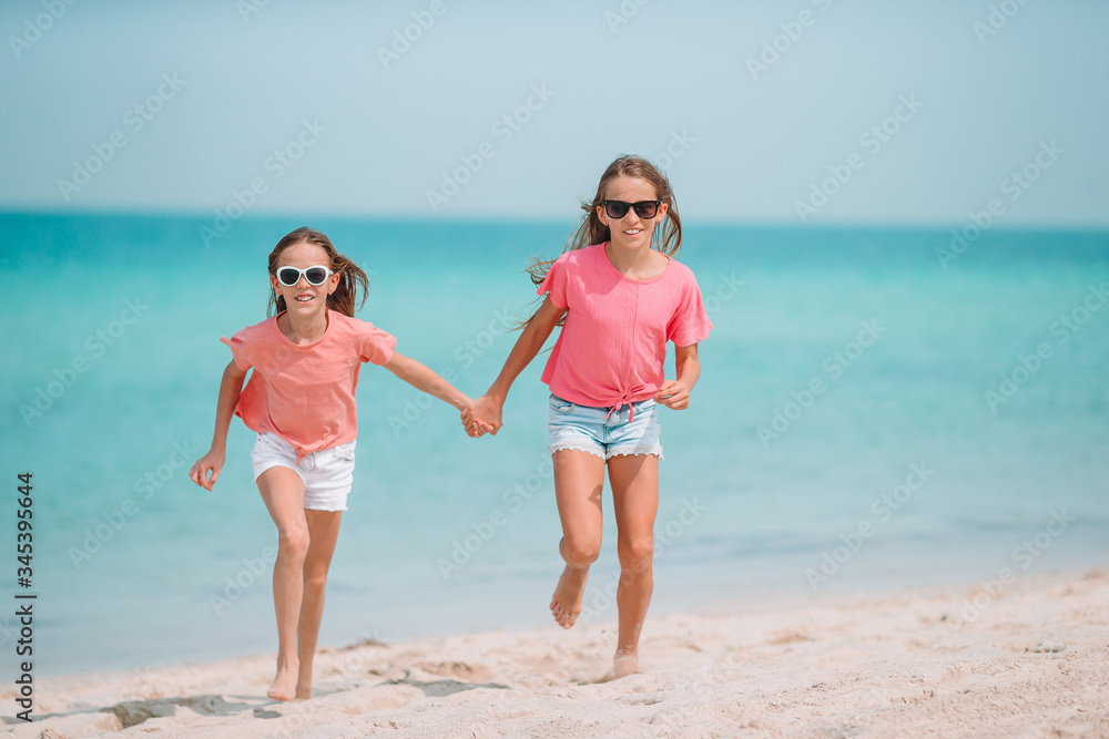 Adorable little girls having fun on the beach Adorable little girls having fun on the beach