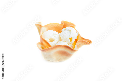 White ice cream balls in waffle basket isolated on white background