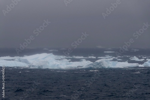 Icebergs in antarctic sea during storm  with dark ocean  Antarctica
