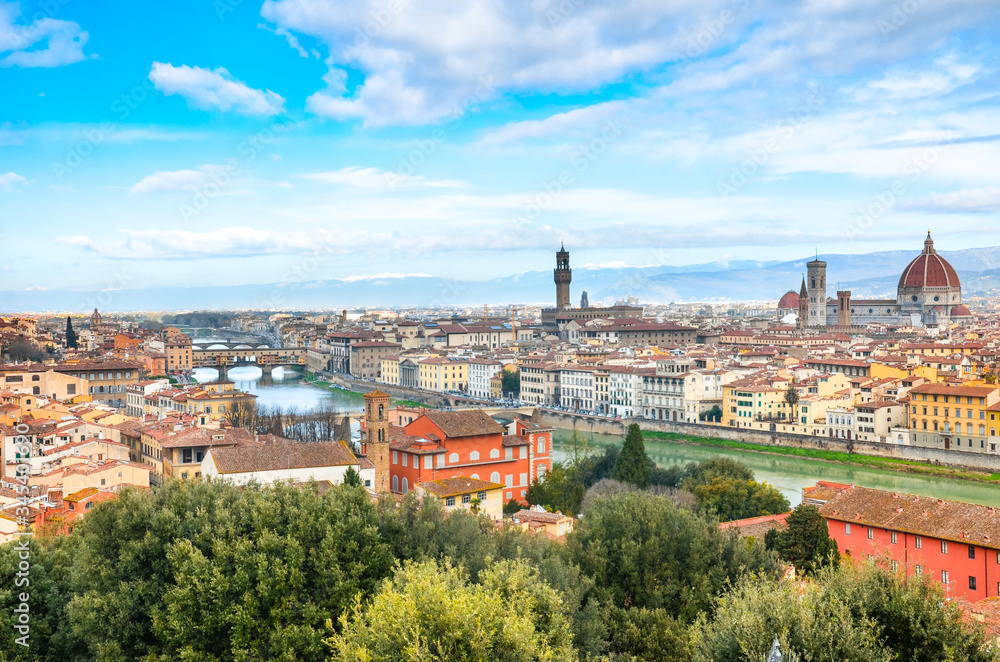 Amazing cityscape of Florence, Tuscany, Italy. Historical city center along Arno river with major sights Ponte Vecchio Bridge and Santa Maria Cathedral. Mountains in the background