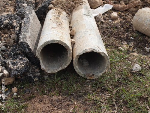 Old asbestos cement pipes on the construction site.