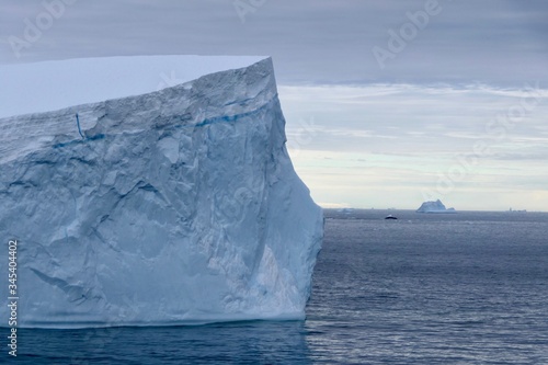 Iceberg in antarctic ocean with stormy sky, Antarctica