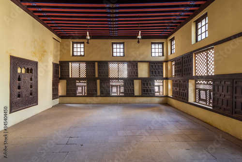 Interior wall with decorated lattice wooden windows, Mashrabiya, and sliding wooden shutters at ottoman era Amasely historic house, Rosetta City, Egypt photo