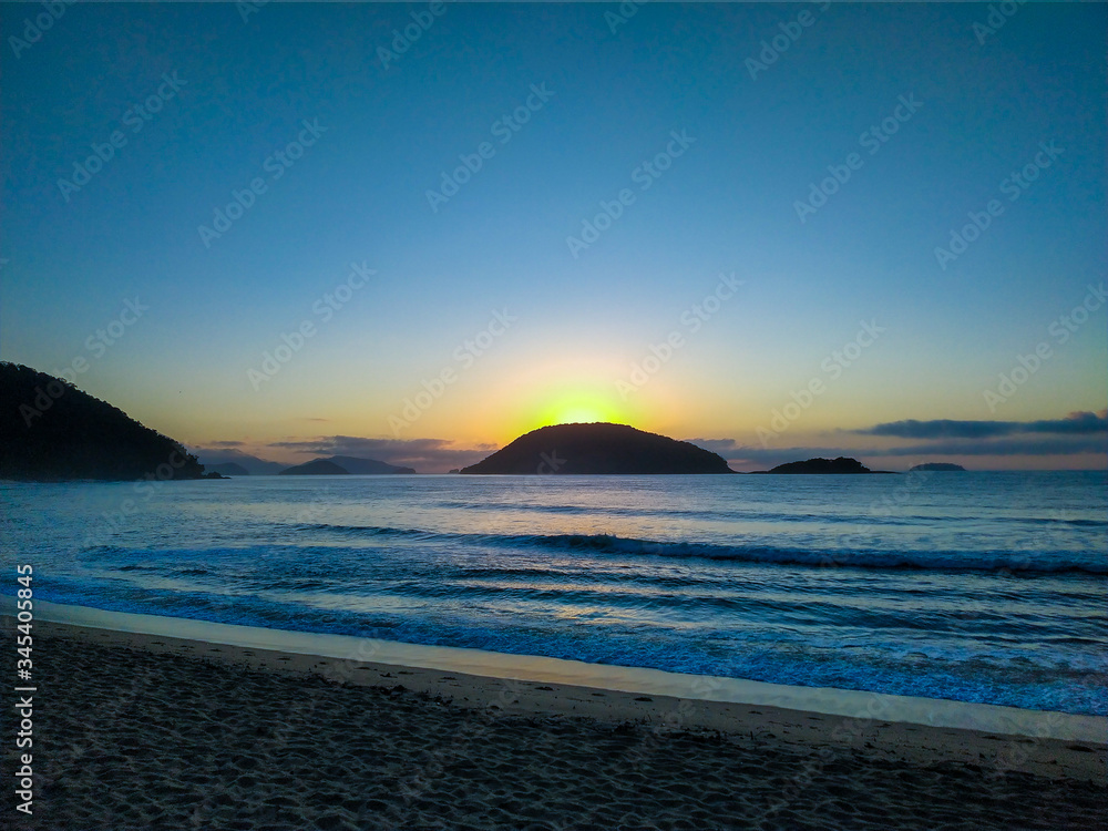 Fototapeta premium Beach at dawn.sunset, sea, beach, sky, water, ocean, landscape, sunrise, sun, nature, coast, island, waves, blue, clouds, dusk, horizon, wave, sand, cloud, lake, travel, dawn, mountain, evening