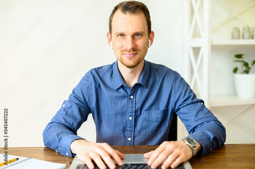 Webcam view of young handsome man in blue smart casual shirt, he is typing  on the keyboard and watching on the screen. Video chat, video call, online  conference Stock Photo | Adobe