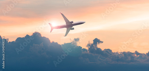 Commercial airplane, aircraft in the sky during sunset, evening sky and passenger plane