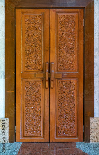 Wooden door decorated by tradional thai ornament