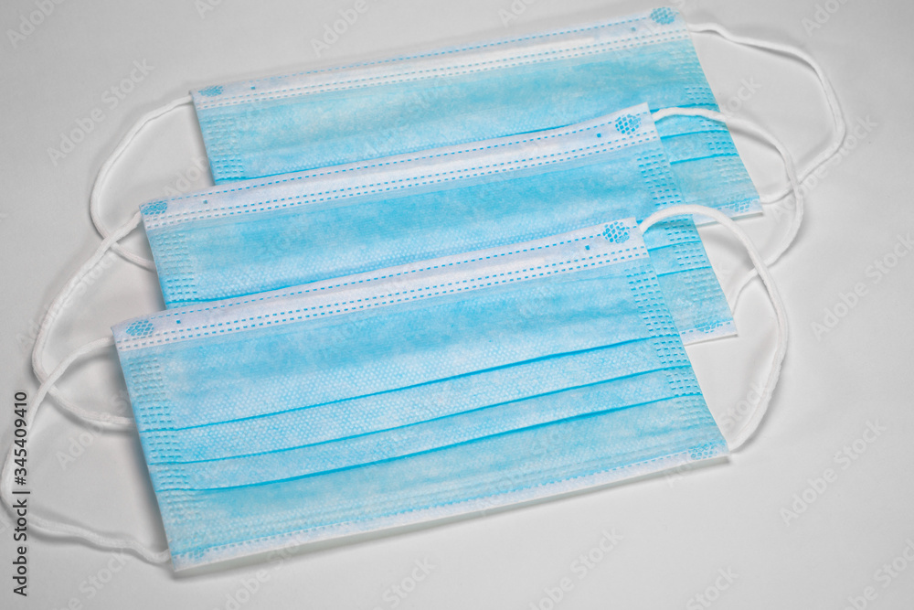 Medical sterile disposable masks. Blue medical masks on a white background. Medical sterile disposable masks. Blue medical masks on a white background.