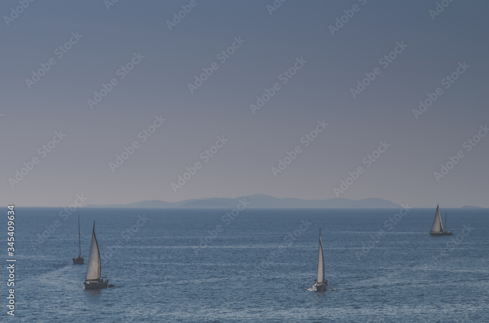 boats sailing on the wide blue sea