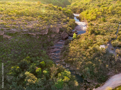 Aeirial of Rio Preto river and Canyon after Cachoeira do Riachinho falls  surrounded by caatinga vegetation landscape at Vale do Capao  Bahia  Brazil. Drone moving forward
