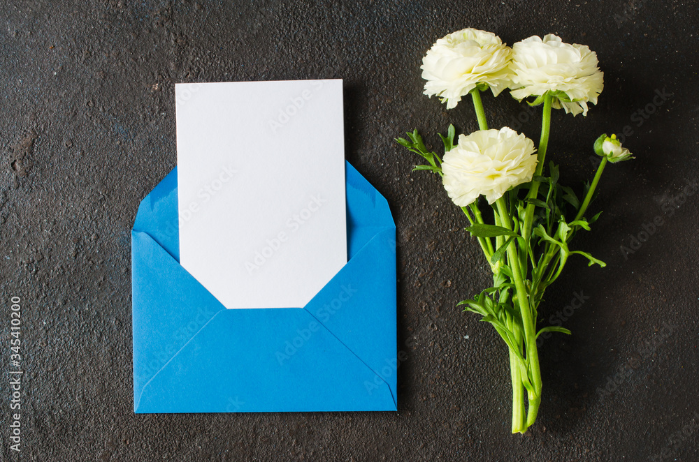 Blue envelope with blank white paper and bouquet of white flowers. Greeting card for Father's or Grandfather's Day. Blue envelope with blank white paper and bouquet of white flowers. Greeting card for Father's or Grandfather's Day.