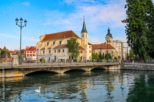 Church of Saint Francois de Sales in Annecy, France. White swan is swimming on Thiou river