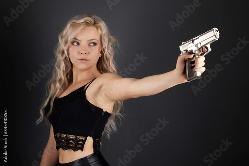Wallpaper Mural A beautiful blonde model holds a pistol for protection Torontodigital.ca