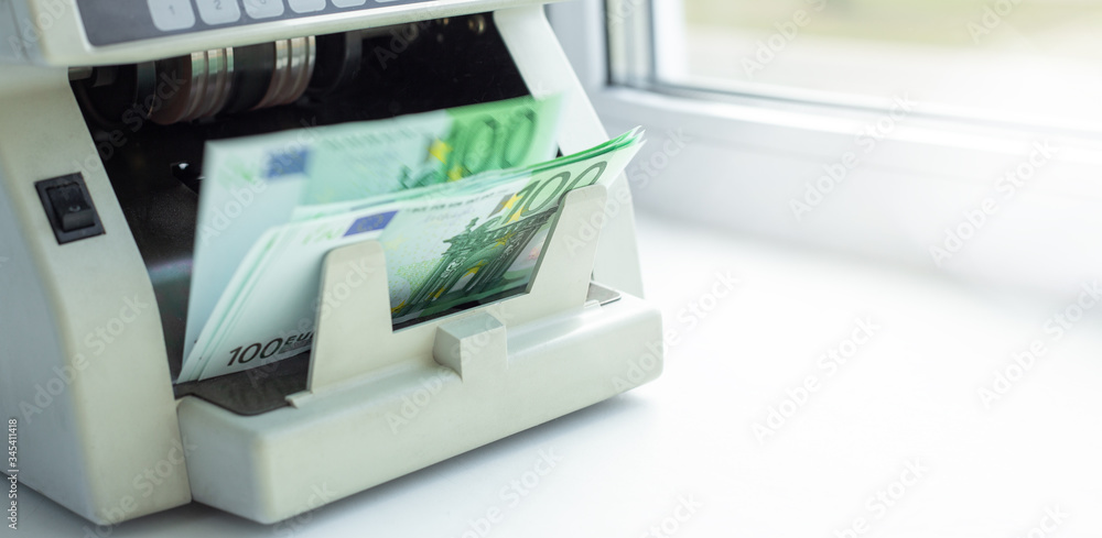 Euro currency on money counting machine. Automatic money counting in the machine Euro currency on money counting machine. Automatic money counting in the machine