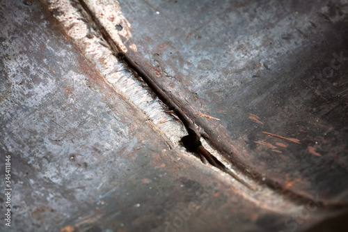 Fragment of the main pipeline. Gas supply to an industrial facility. In the frame, the weld defect is a hole and a crack on the steel pipe.