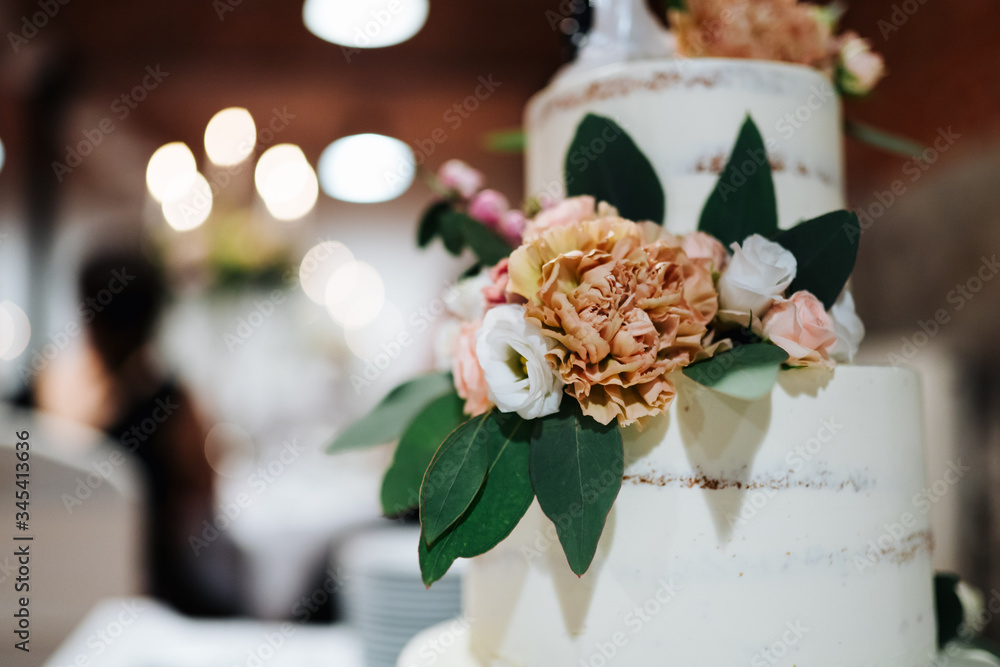 Obraz premium photo of a layered wedding cake with flowers