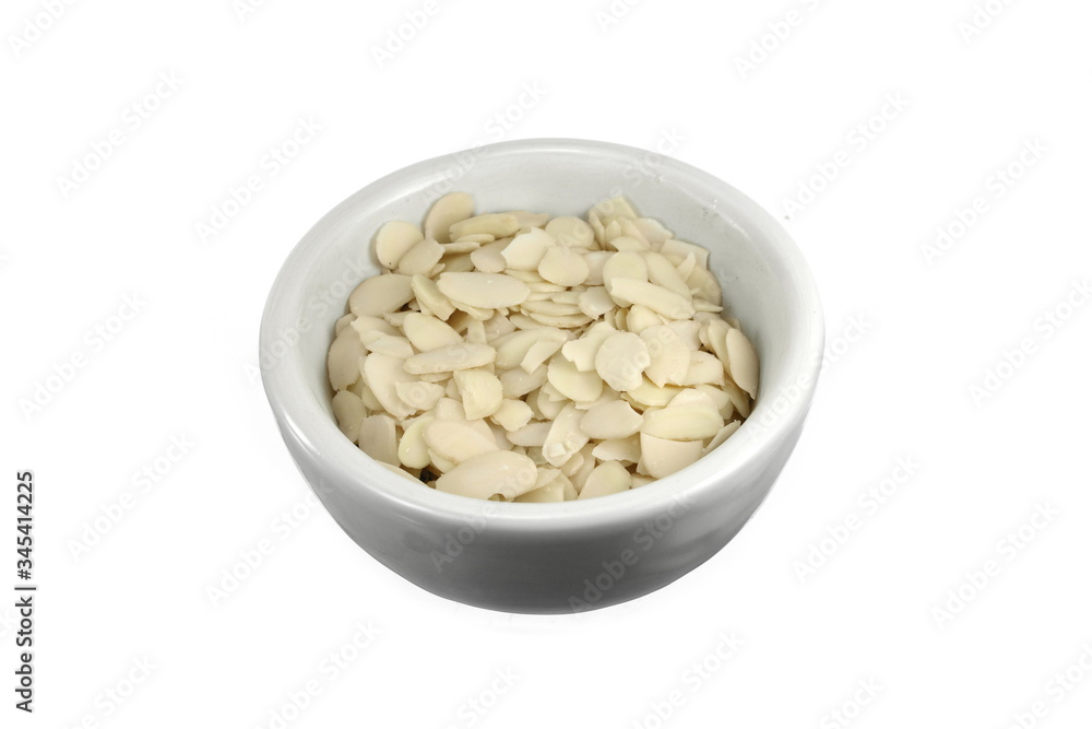 Pile of peeled flaked almonds isolated on white. Blanched almonds flakes on white. Pile of peeled flaked almonds isolated on white. Blanched almonds flakes on white.