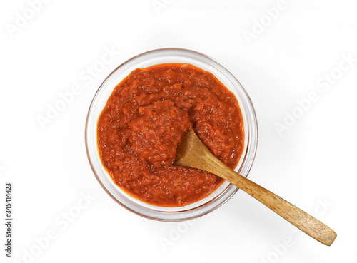 Bowl with red pesto isolated on white background. Bowl of traditional Italian red pesto isolated on white from above.