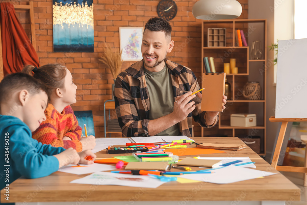 Fototapeta premium Drawing teacher giving optional classes at school