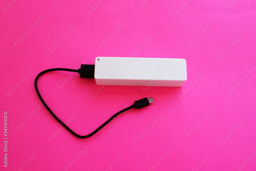 External battery with a USB port on a bright background, modern technology. External battery with a USB port on a bright background, modern technology.