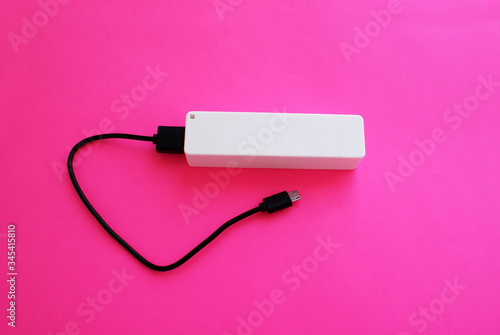 External battery with a USB port on a bright background, modern technology.