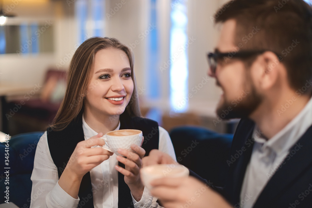 Young business people drinking coffee in cafe Young business people drinking coffee in cafe