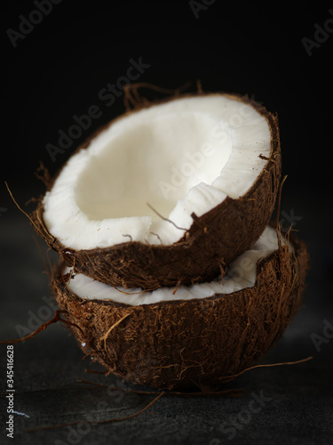Coconut halves on a dark background.